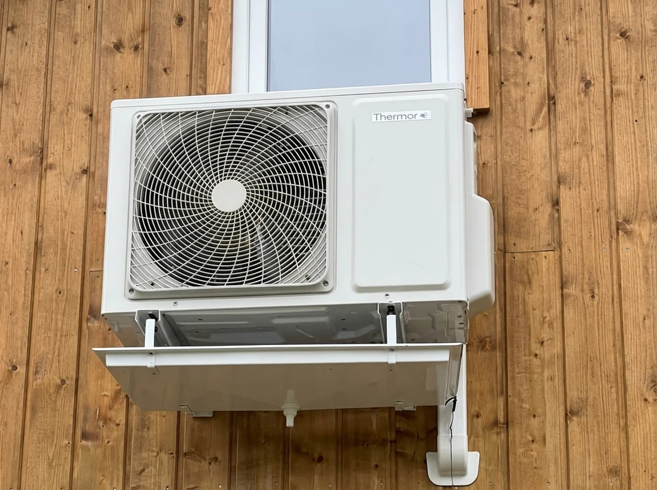 Unité intérieure de climatisation réversible murale, marque Mitsubishi Electric, modèle MSZ, installée en position haute sur un mur à enduit décoratif beige